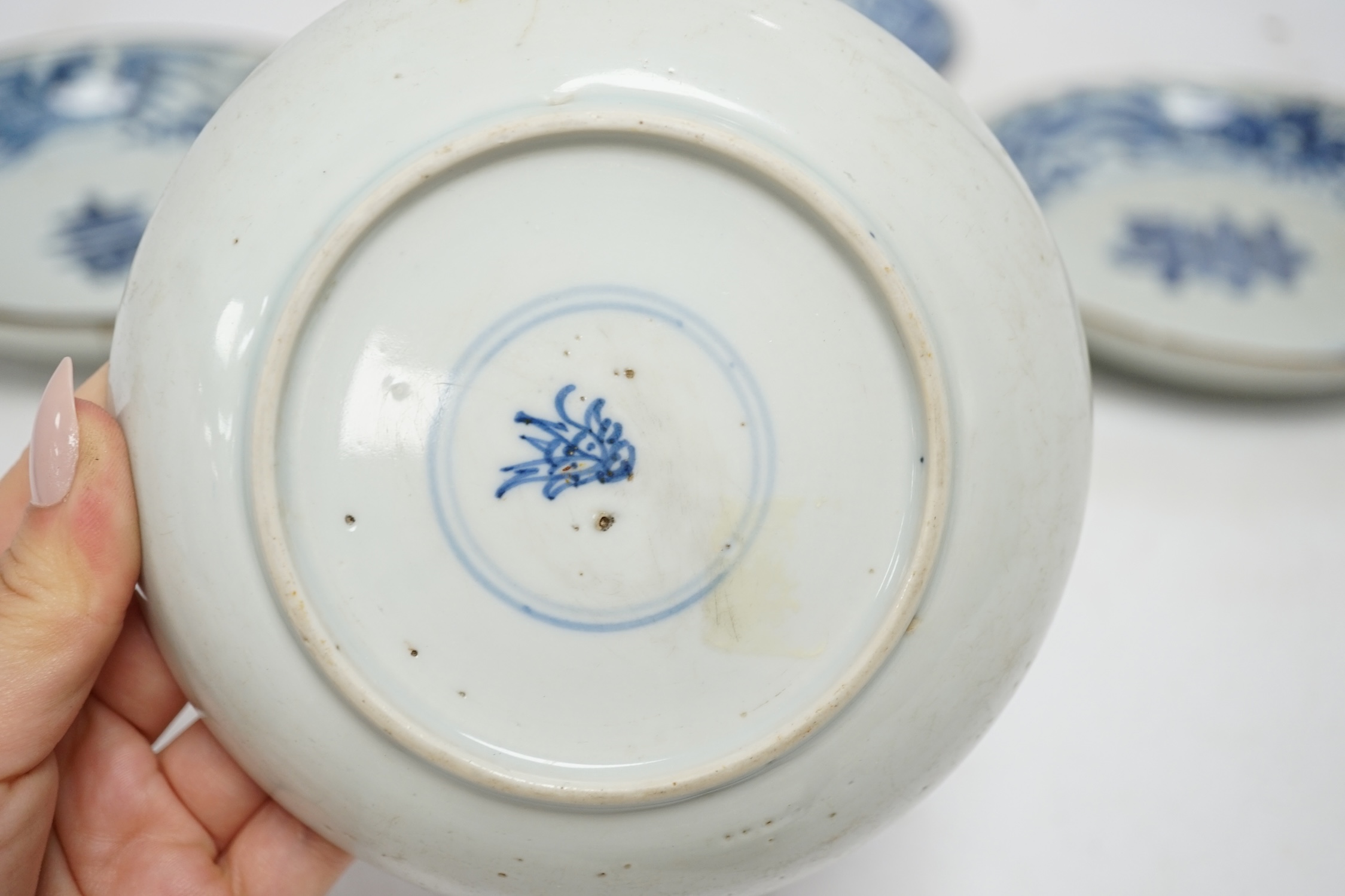 Five variously patterned Chinese blue and white saucer dishes, Kangxi period, largest 16cm diameter. Condition - chips and cracks to three items